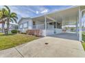 Inviting single-story home with carport, a front porch, and neatly landscaped yard at 1404 44Th E Ave, Ellenton, FL 34222