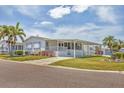 Inviting single-story home featuring a carport, well-kept lawn, and front porch at 1404 44Th E Ave, Ellenton, FL 34222
