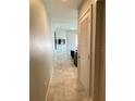 Hallway leading to a living area with a mounted TV, complemented by modern tile flooring at 1500 State St # 401, Sarasota, FL 34236