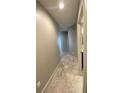 Hallway featuring neutral paint and tile floors, leading to various rooms within the unit at 1500 State St # 401, Sarasota, FL 34236
