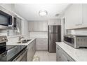 Modern kitchen with stainless steel appliances, granite countertops, and ample cabinet space at 2008 Canal Dr # M3, Bradenton, FL 34207