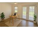 Bright office space with tiled floors, natural light, and double french doors leading to outdoor area at 22343 Lasalle Rd, Port Charlotte, FL 33952