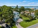 Beautiful two-story home with lush landscaping, mature trees, and stunning waterfront views at 3405 10Th W St, Palmetto, FL 34221