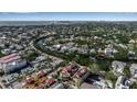 Aerial view of neighborhood featuring tile roofed homes near a canal, surrounded by green foliage at 436 Canal Rd # A, Sarasota, FL 34242