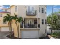 Beige three-story home featuring multiple balconies, a ground-level patio and a garage at 436 Canal Rd # A, Sarasota, FL 34242
