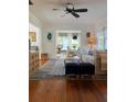 Cozy living room with hardwood floors, stylish furniture, and a view into the dining area at 4704 Winchester Dr, Sarasota, FL 34234