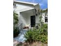 Inviting porch with wrought iron accents, potted plants, and well-maintained steps leading to the entrance at 4704 Winchester Dr, Sarasota, FL 34234