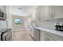 Clean, bright kitchen featuring stainless steel appliances and white cabinets at 4861 Waterbridge Down, Sarasota, FL 34235