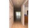 Hallway view featuring tile floors, a coat closet, and light-filled rooms at 5057 Live Oak Cir # 86, Bradenton, FL 34207