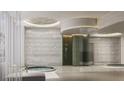 Modern spa featuring a hot tub, walk-in shower, and textured tile, perfect for relaxation and wellness at 555 Quay Cmn # 405, Sarasota, FL 34236