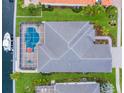 Stunning aerial view of backyard oasis with screened pool, manicured lawn, and boat dock at 569 Mast Dr, Bradenton, FL 34208