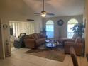 Spacious living room featuring vaulted ceilings, neutral tones, large windows, and comfortable seating arrangement at 5712 34Th W Ct, Bradenton, FL 34210