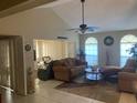 Bright living room with vaulted ceiling, tile floors, comfortable seating, and abundant natural light at 5712 34Th W Ct, Bradenton, FL 34210