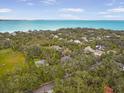 Panoramic aerial view showcasing a beautiful waterfront community with lush greenery and clear blue water at 5716 Bayshore Blvd, Tampa, FL 33611