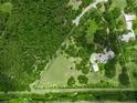 An aerial shot of a large property with lush greenery and a modern home inside a defined property line at 7234 Letitia Ln, Sarasota, FL 34241
