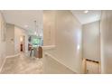 Inviting hallway featuring neutral walls, ceramic tile floors, and access to an open-concept living space at 8352 Enclave Way # 104, Sarasota, FL 34243