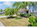 Beautiful home features mature palm trees and lush landscaping enhancing curb appeal at 9052 41St E St, Parrish, FL 34219