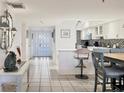 Inviting foyer leading to an open kitchen and dining area, creating a seamless transition between spaces at 1065 Gulf Of Mexico Dr # 103, Longboat Key, FL 34228