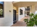 Exterior hallway with unit entrance and greenery, creating a pleasant walkway to the residence at 1065 Gulf Of Mexico Dr # 103, Longboat Key, FL 34228