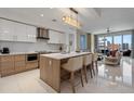 The kitchen features a large kitchen island with bar stool seating, modern appliances, and ample storage at 111 S Pineapple Ave # 716, Sarasota, FL 34236