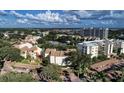 An aerial view showcases the neighborhood, community pool and a tranquil lake view at 1200 Cove Ii Pl # 832, Sarasota, FL 34242