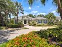 Beautifully landscaped home with mature trees and vibrant flowerbeds creates an inviting and picturesque setting at 12311 Newcastle Pl, Lakewood Ranch, FL 34202