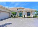 Inviting home showcasing a well-maintained lawn, symmetrical landscaping, and a circular driveway design at 12811 Penguin Dr, Bradenton, FL 34212