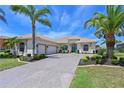 Charming single-Gathering home with a well-manicured lawn, mature palm trees and a spacious driveway at 12811 Penguin Dr, Bradenton, FL 34212