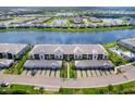 Aerial view showcasing the community with lush landscaping, serene lake, and convenient pool at 14214 Heritage Landing Blvd # 817, Punta Gorda, FL 33955