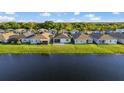 Backyard view of several homes with a serene pond in the community at 14444 59Th E Cir, Bradenton, FL 34211