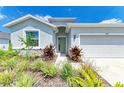 Charming single-Gathering home featuring a landscaped front yard and a welcoming green front door at 16109 6Th E Ave, Bradenton, FL 34212
