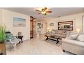 Bright living room with neutral paint, ceiling fan, tile floors, and comfortable seating arrangement at 1731 Redwood St, Sarasota, FL 34231