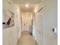 Bright hallway featuring neutral colors and decorative art leading to other rooms in the home at 17510 Gawthrop Dr # 206, Bradenton, FL 34211