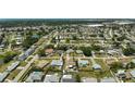 This aerial view showcases the property's location within a sprawling residential area near parks and a distant cityscape at 1789 Elm Dr, Venice, FL 34293