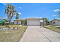 An inviting single-Gathering home boasts a two-car garage and simple landscaping, complemented by a well-maintained front yard at 1789 Elm Dr, Venice, FL 34293