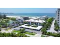 Beautiful exterior view of the condominium buildings with covered parking and manicured landscaping near the beach at 2100 Benjamin Franklin Dr # 201, Sarasota, FL 34236
