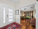 Inviting entryway featuring hardwood floors, contemporary accents, and a view into the beautifully decorated living room at 2282 Harbour Court Dr, Longboat Key, FL 34228