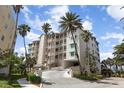 Multi-story condo building with lush landscaping and palm trees offering a beautiful coastal living experience at 242 Hidden Bay Dr # 603, Osprey, FL 34229