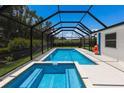 Screened in pool and hot tub offers a private oasis for relaxation and recreation at 2560 Sunnyside St, Sarasota, FL 34239