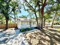 Charming single-story home nestled amongst mature trees, with a inviting front porch at 2721 7Th W St, Bradenton, FL 34205