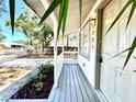 Inviting front porch with a view of the street and well-maintained landscaping at 2721 7Th W St, Bradenton, FL 34205