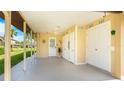 Spacious carport with ample storage, a ceiling fan, and access to the main house, providing convenient sheltered parking at 3213 Cambridge Ave, Bradenton, FL 34207