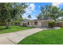 Single-story home with attached garage and well-maintained lawn, front view at 3301 62Nd Street W Cir, Bradenton, FL 34209