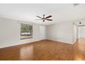 Well-lit living room showcasing hardwood floors, a ceiling fan, and a bright window at 3301 62Nd Street W Cir, Bradenton, FL 34209