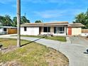 Exterior view of a single-story home featuring a spacious driveway and lawn with landscaping at 4221 26Th W St, Bradenton, FL 34205