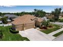 Beautifully landscaped single-Gathering home with a three-car garage, lush lawn, and meticulously maintained landscaping at 4706 Josselin Pl, Parrish, FL 34219