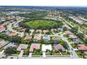 Beautiful aerial view of the neighborhood with lush trees, serene lakes, and well-maintained homes at 5106 Far Oak Cir, Sarasota, FL 34238