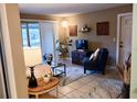 Cozy living room with tile floors, neutral walls, and comfortable seating arrangement at 5400 26Th W St # F104, Bradenton, FL 34207