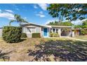 Charming single Gathering home with a blue door and a spacious front yard at 6720 Northampton Pl, Bradenton, FL 34207