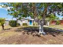 Charming single-story home with a bright blue door and carport offers a cozy curb appeal at 6720 Northampton Pl, Bradenton, FL 34207